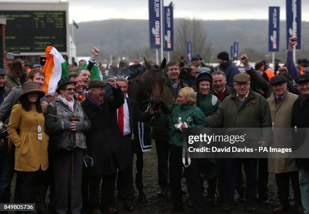 Jockey Colman Sweeney and the connections of Salsify celebrate after winning the CGA Foxhunter Chase Challenge Cup during Cheltenham Gold Cup Day, at...