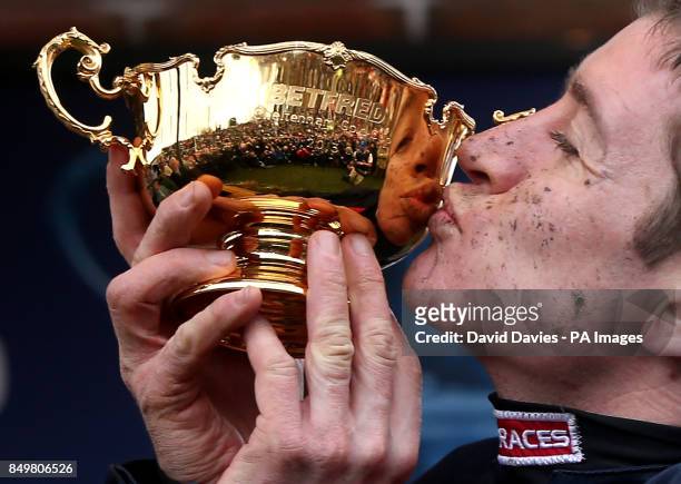 Jockey Barry Geraghty kisses the Gold Cup after his victory on Bobs Worth during the Cheltenham Gold Cup Day on Day Four of the 2013 Cheltenham...