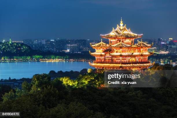 illuminated chenghuang pagoda against west lake,hangzhou,china - west lake hangzhou stock pictures, royalty-free photos & images