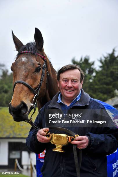 Winner of the Cheltenham Gold Cup 2013 Bobs Worth with his trophy, held by trainer Nicky Henderson, during the homecoming parade at Nicky Henderson's...