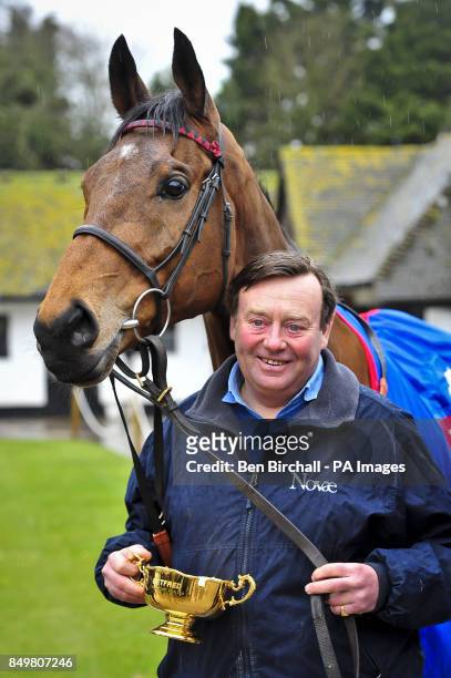 Winner of the Cheltenham Gold Cup 2013 Bobs Worth with his trophy, held by trainer Nicky Henderson, during the homecoming parade at Nicky Henderson's...