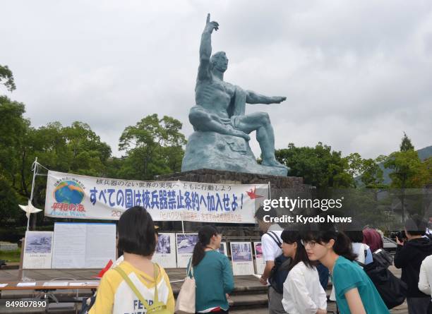People gather at the Nagasaki Peace Park on Sept. 20 in the atomic-bombed southwestern Japan city of Nagasaki to promote a signature-collecting...