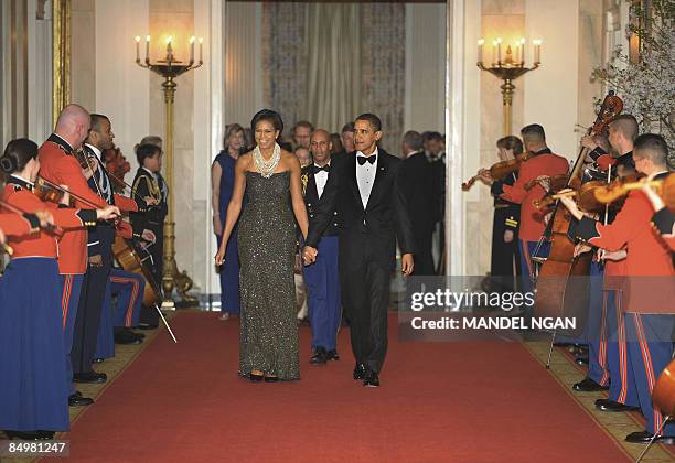 President Barack Obama and First Lady Michelle Obama make their way to the East Room for after dinner entertainment with US governors February 22,...