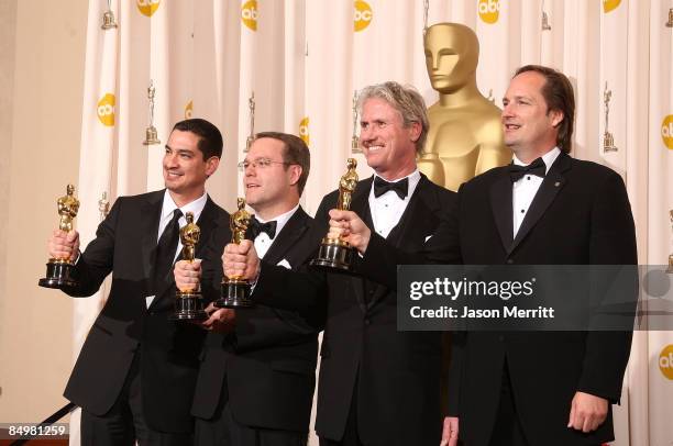 Visual effects artists Eric Barba, Steve Preeg, Burt Dalton and Craig Barron pose in the press room with their Best Visual Effects award for "The...