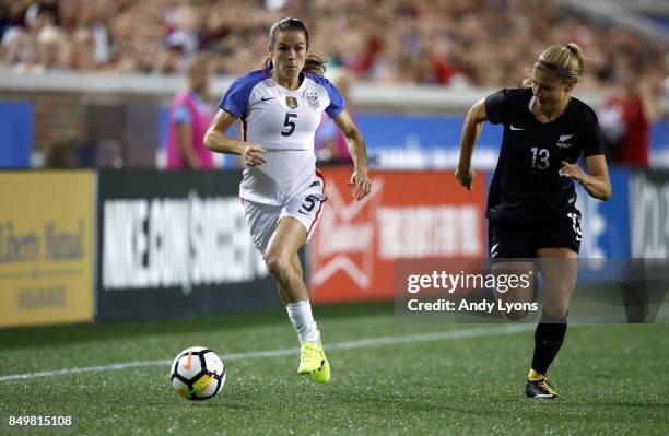 Kelley O'Hara of the USA advances the ball down the field while defended by Rosie White of New Zealand at Nippert Stadium on September 19, 2017 in...