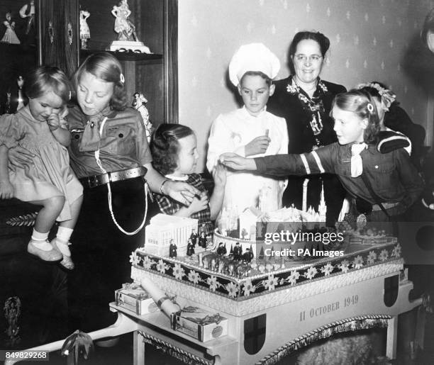 The daughters of Queen Beatrix and Prince Bernhard of the Netherlands sample a cake given to them on a visit to Overijsel province. Princess Marijke,...