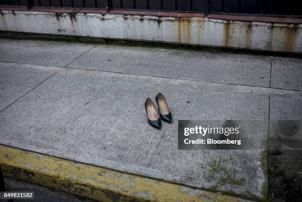 Pair of high-heeled shoes sit on a sidewalk following an earthquake in Mexico City, Mexico, on Tuesday, Sept. 19, 2017. A powerful 7.2 magnitude...