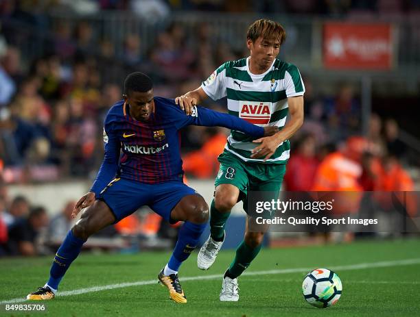 Nelson Semedo of Barcelona competes for the ball with Takashi Inui of Eibar during the La Liga match between Barcelona and Eibar at Camp Nou on...