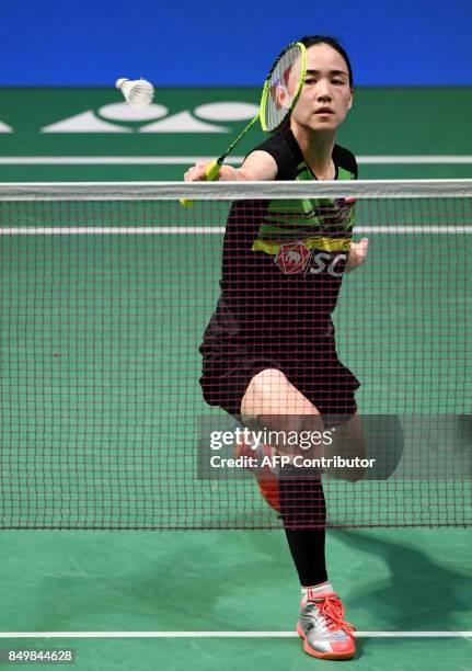 Nitchaon Jindapol of Thailand hits a return to Beiwen Zhang of the US during their women's singles first round match at Japan Open Badminton...