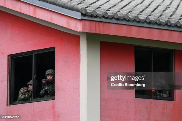 South Korean army soldiers take position and aim their weapons from a window during Warrior Strike VIII, a bilateral training exercise between the...