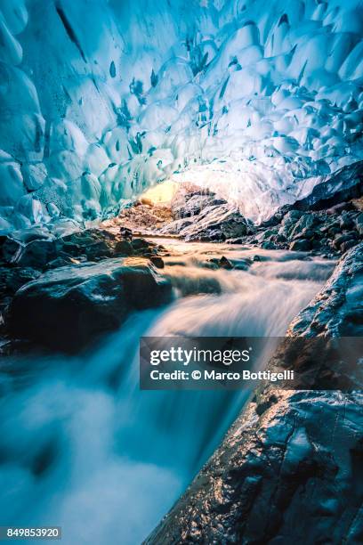 waterfall in an ice cave, iceland - iceland cave stock pictures, royalty-free photos & images