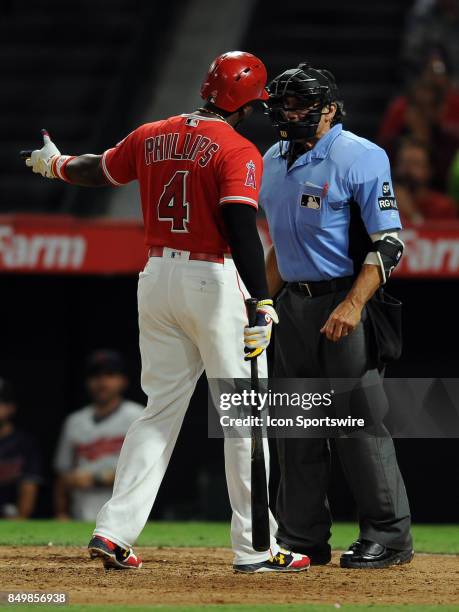 Los Angeles Angels of Anaheim second baseman Brandon Phillips argues with home plate umpire Phil Cuzzi after being called out on a called third...