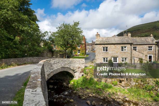 the picturesque village of thwaite in upper swaledale, north yorkshire, england - yorkshire dales national park stock pictures, royalty-free photos & images