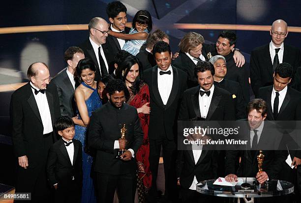 Producer Christian Colson with actors Freida Pinto , Irrfan Khan, Anil Kapoor and composer AR Rahman celebrate winning the Best Picture award for...