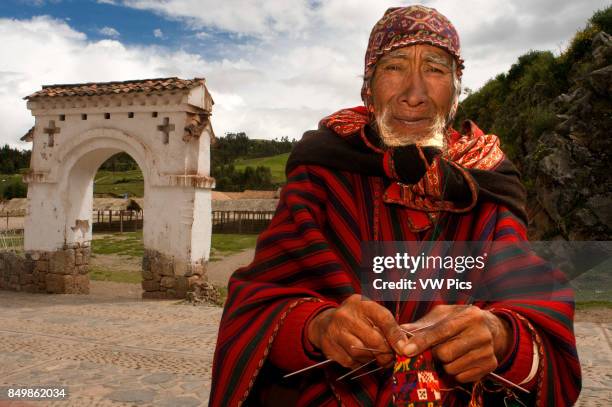 An artisan weaves a hat on the streets of Chinchero in the Sacred Valley near Cuzco. Chinchero is a small Andean Indian village located high up on...