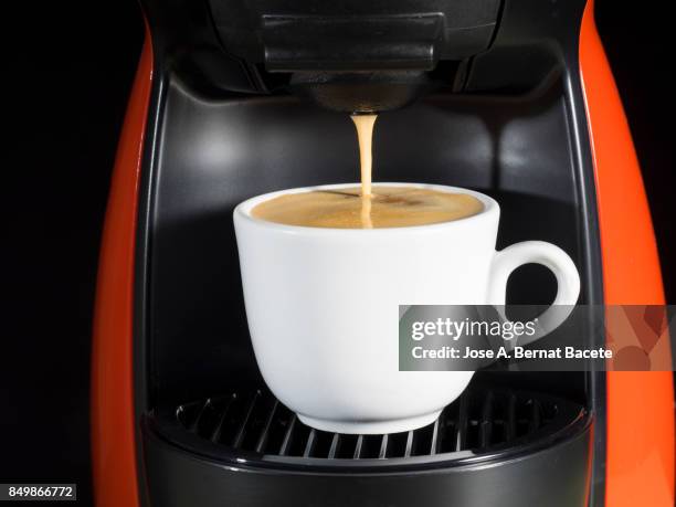 machine of coffee of capsules with a cup of warm and creamy coffee - coffee capsules stock pictures, royalty-free photos & images