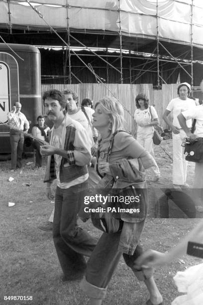 Former Beatles star Paul McCartney and his wife Linda - both members of wings pop group - at Knebworth Park when they attended the day-long concert...