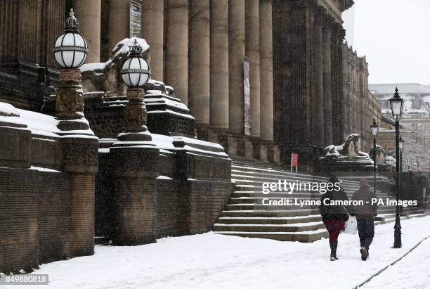 People walking past the town hall in Leeds city centre.