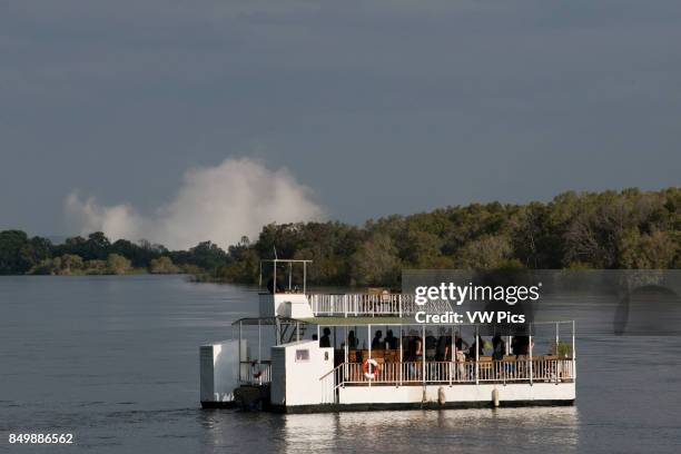 Cruise along the Victoria Falls aboard the ' African Queen'. Other boats sailing in the Zambezi River. The sunset cruises vary in boat size _ from...