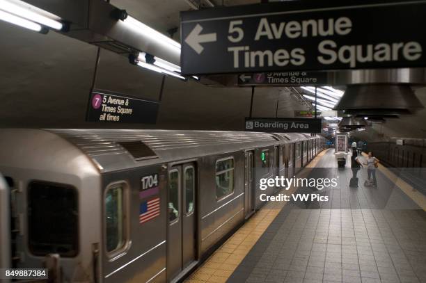 United States of America, New York, New York City, Manhattan, Subway Station and train in motion.