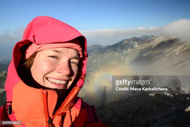 selfie of a female hiker with brocken spectre optical phenomenon shadow - light natural phenomenon stock pictures, royalty-free photos & images