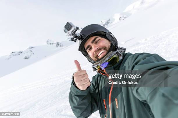 skier, snowboarder taking a selfie at the mountain - go pro camera imagens e fotografias de stock