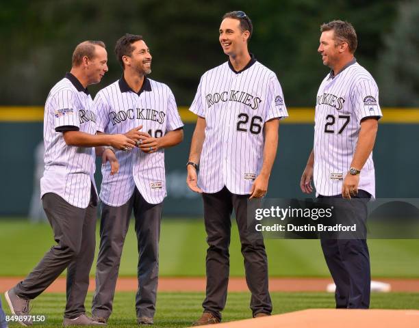 Members of the 2007 Colorado Rockies team, from left, Cory Sullivan, Ryan Spilborghs, Jeff Francis, and Garrett Atkins, stand on the field during a...