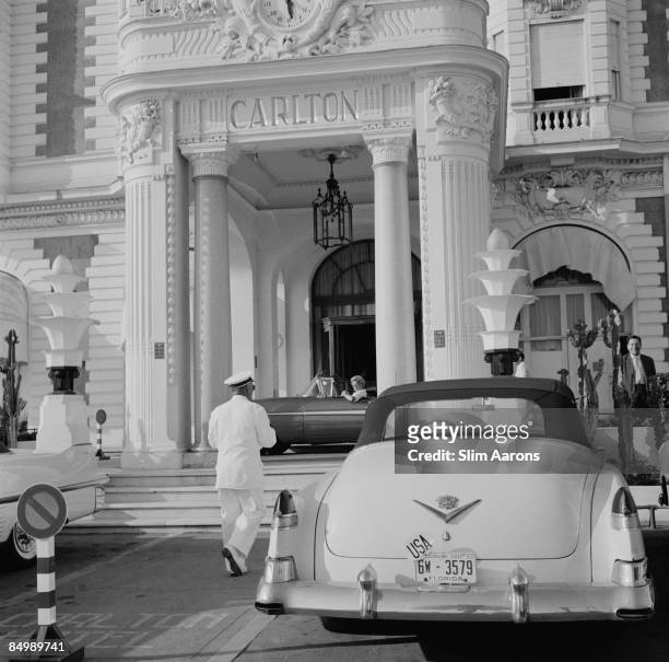 Cadillac with Florida plates parked outside the Carlton Hotel, Cannes, France, circa 1955.