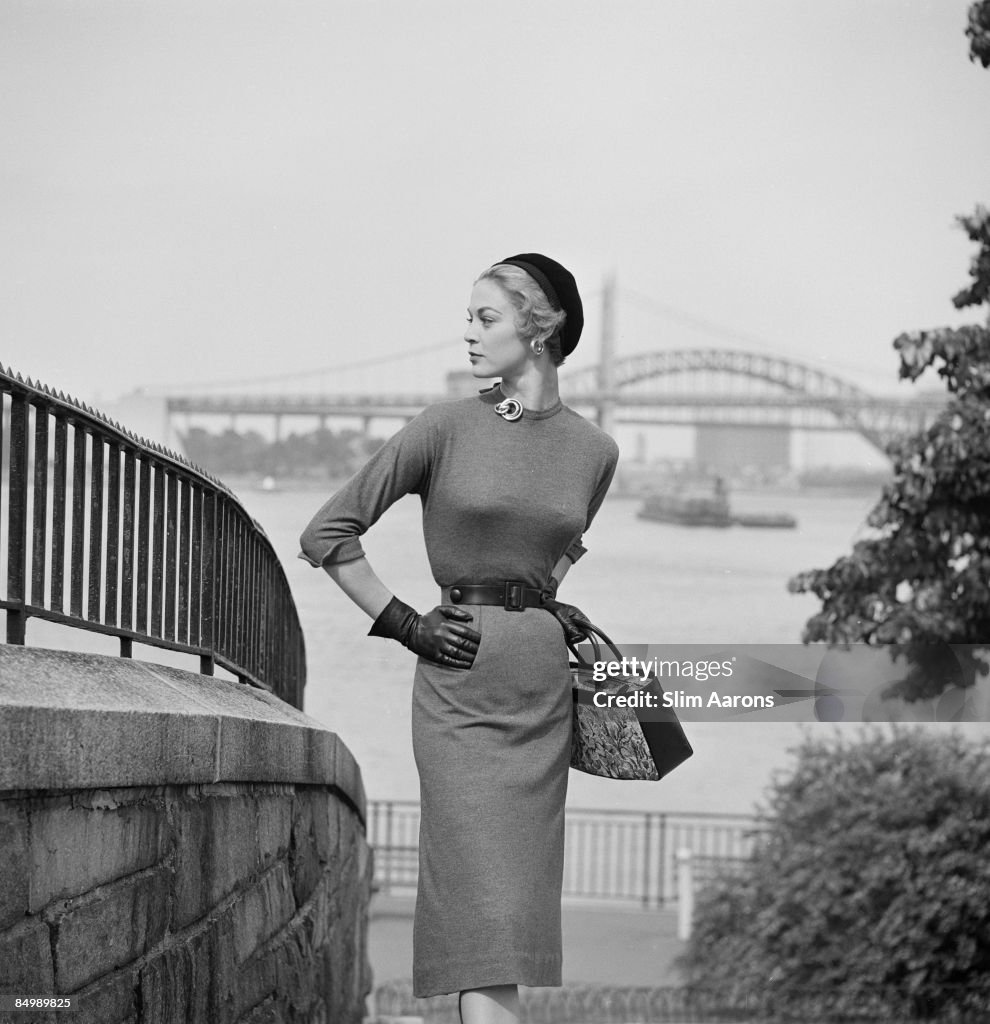 A young woman modelling a belted dress with pencil skirt, New York