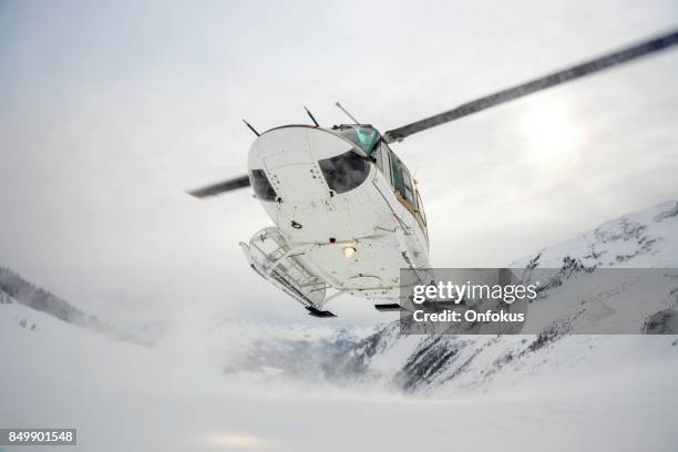 helicopter landing on mountain summit, heli-skiing - heli skiing stock pictures, royalty-free photos & images