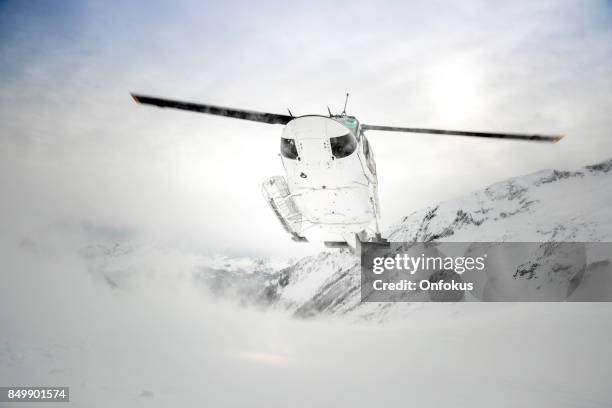 helicopter landing on mountain summit, heli-skiing - heli skiing stock pictures, royalty-free photos & images