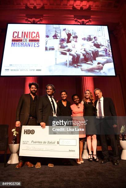 Maxim Pozdorovkin, Steven Larson, Jackie Gagne, Karine Jeane-Pierre, Daphne Owens, and Jack Ludmir, pose on stage with check for 10,000 presented by...