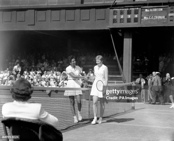 Great Britain's Christine Truman is congratulated by Althea Gibson from the USA after winning 2-6, 6-3, 6-4 in a Wightman Cup tennis match at...