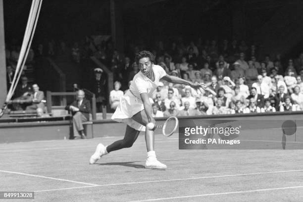 The USA's Althea Gibson during play in a Wightman Cup tennis match against Christine Truman at Wimbledon. The 17-year-old from Great Britain went on...