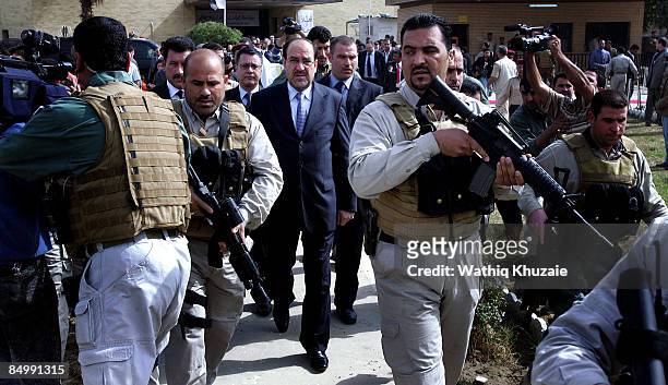 Iraqi Prime Minister Nuri al-Maliki surrounded by his bodyguards arrives at the reopening ceremony of Iraq National Museum on February 23, 2009 in...