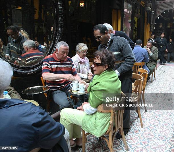 Small group of German tourists visit the popular El-Fishawi coffee shop in the tourist bazaar close to the Al-Hussein mosque in Cairo on February 23...
