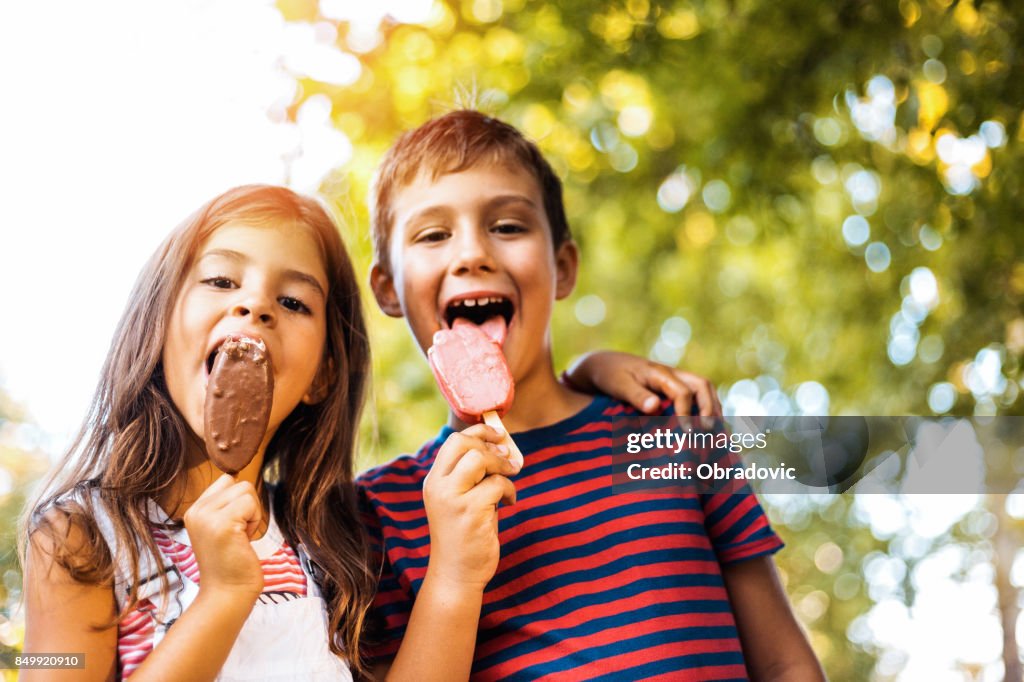 Two children eating popsicle