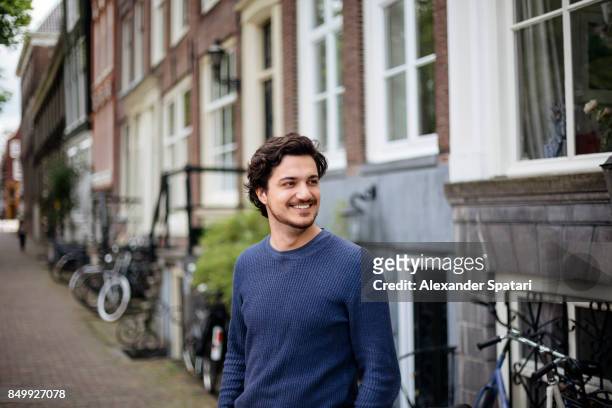 portrait of a young handsome man on the streets of amsterdam - dutch culture stock pictures, royalty-free photos & images