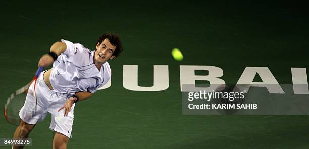 British tennis player Andy Murray returns the ball to Sergiy Stakhovsky of the Ukraine on the first day of the ATP Dubai tennis championships in the...