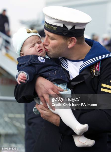 Leading Seaman Kyle Broomhead from Barnsley doesn't quite get the reaction he'd hoped for as he kisses his daughter six month old Phoebe after...
