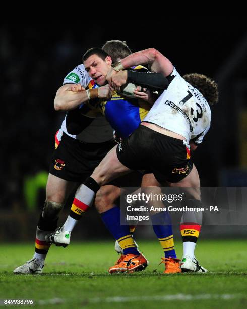 Leeds Rhinos' Ryan Hall is tackled by Bradford Bulls' Nick Scurton and Jamie Langley during the Super League match at Headingley Carnegie, Leeds.