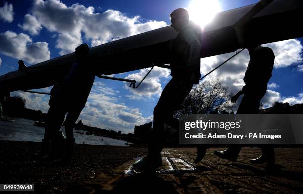 Cambridge University carry their boat out for a training session on the River Thames, London.