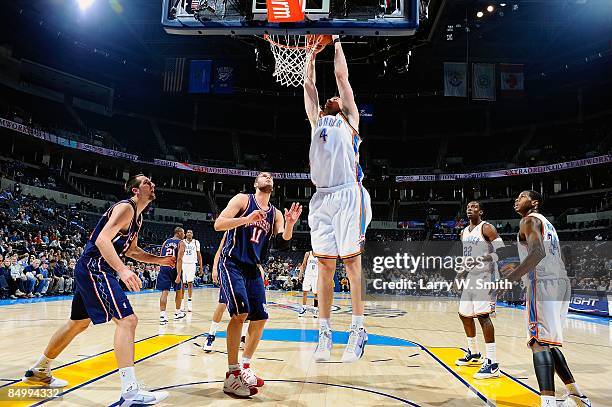 Nick Collison of the Oklahoma City Thunder goes for the dunk over Brook Lopez of the New Jersey Nets during the game on January 26, 2009 at the Ford...