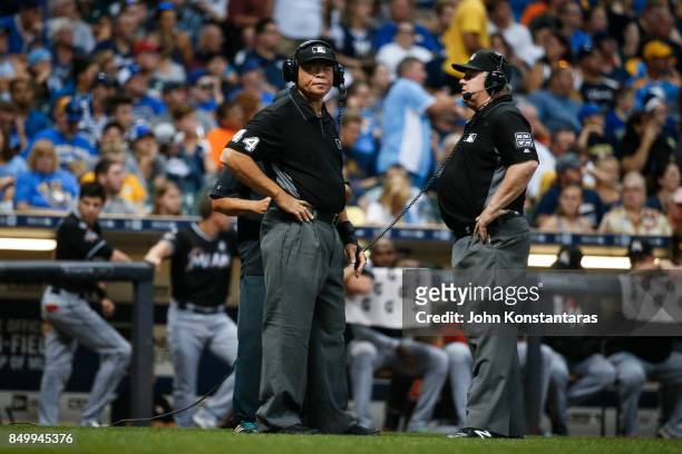 Umpires Kerwin Danley and Bill Miller during a play review in the sixth inning at Miller Park on September 16, 2017 in Milwaukee, Wisconsin. The...