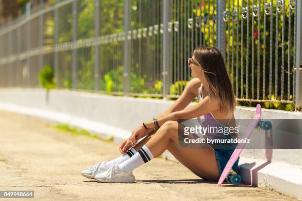 happy girl with skateboard near wall - kids white socks stock pictures, royalty-free photos & images