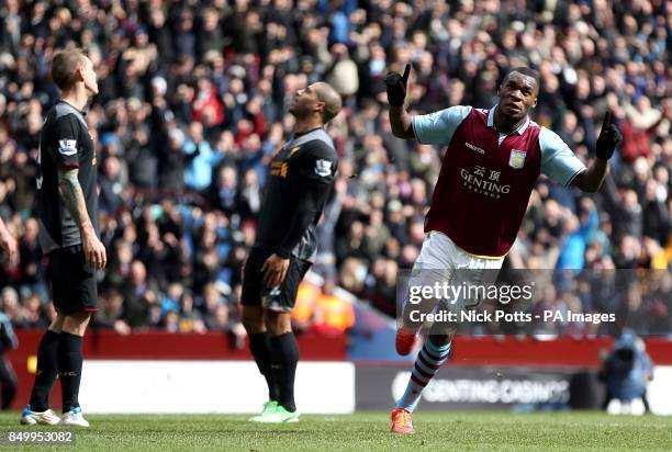 Aston Villa's Christian Benteke celebrates scoring his teams first goal of the game as Liverpool's Glen Johnson and Daniel Agger stand dejected