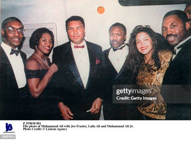 File photo of Muhammad Ali with Joe Frazier, Laila Ali and Muhammad Ali Jr.