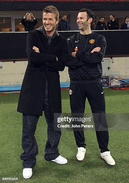 David Beckham of AC MIlan speaks with Ryan Giggs of Manchester United during a training session ahead of their UEFA Champions League Quarter-Final...