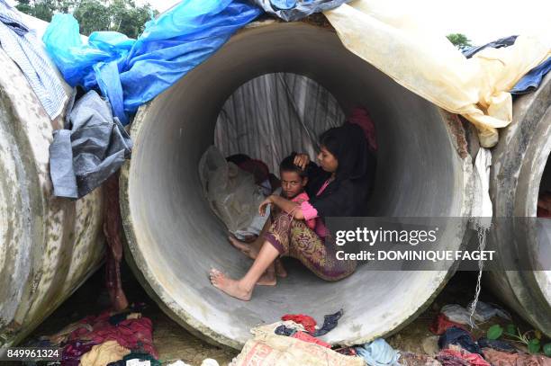 Rohingya Muslim refugees shelter in cement pipes at Kutupalong refugee camp in the Bangladeshi district of Ukhia on September 20, 2017. Bangladesh's...