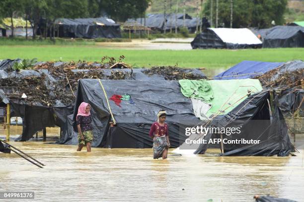 Rohingya Muslim refugees cross floodwater at Thyangkhali refugee camp in the Bangladeshi district of Ukhia on September 20, 2017. Bangladesh's army...